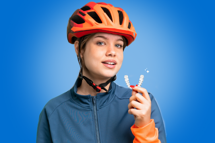 Cyclist girl holding clear aligners