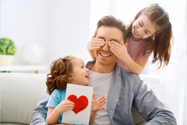 dad smiling with his children on Father’s Day