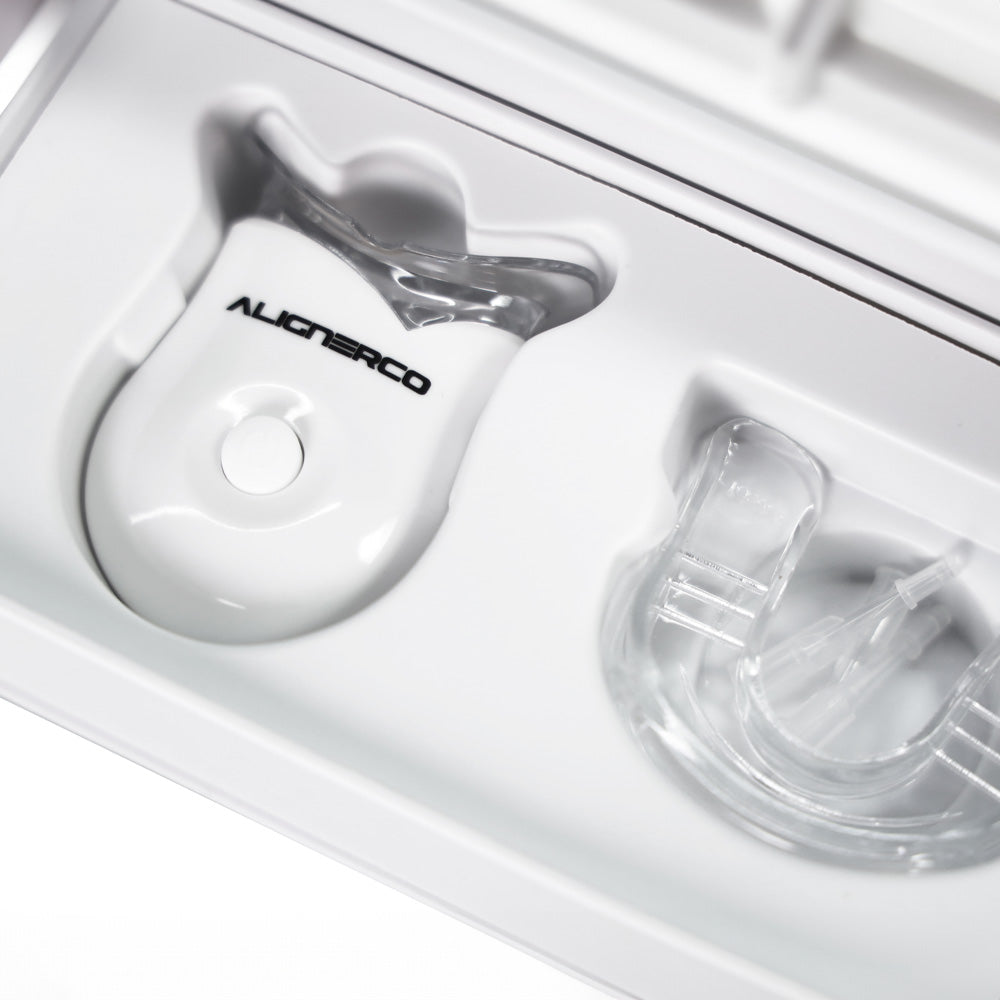 Close-up of Alignerco LED mouthpiece and tray in whitening kit packaging.