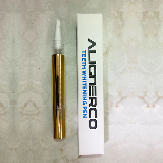 ALIGNERCO teeth whitening pen with gold applicator and branded white packaging.