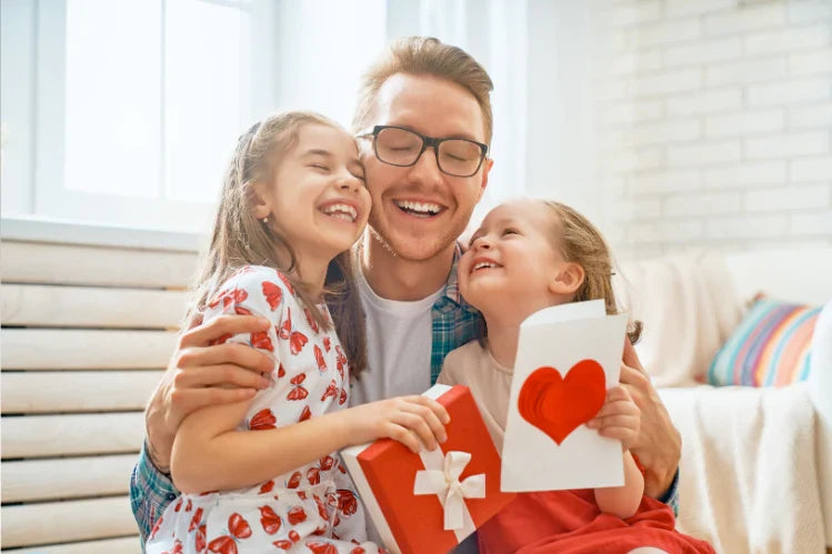 A dad smiling with his children on Father’s Day