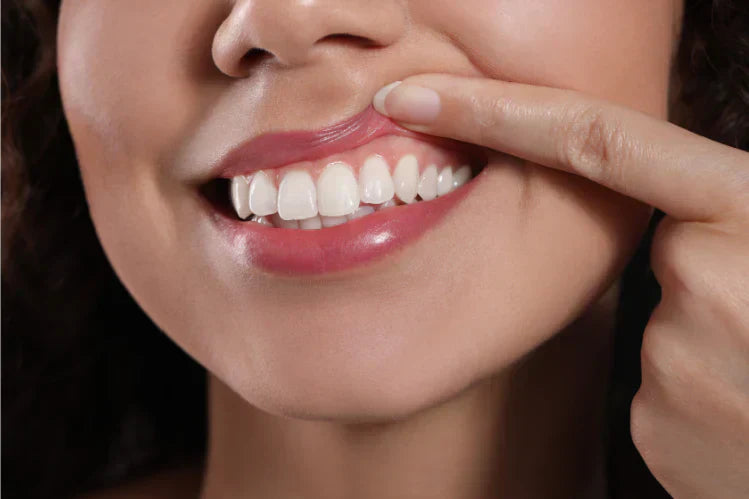 A person lifting their lip to show healthy gums