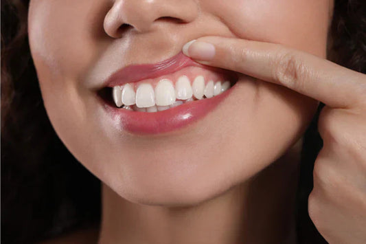 A person lifting their lip to show healthy gums