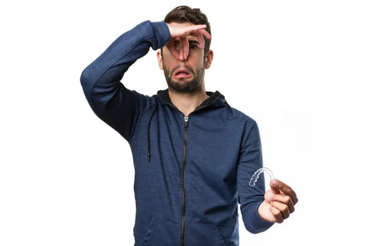 A boy is facing bad breath from smelly aligners
