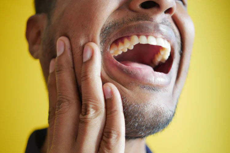 An image of a man suffering from pain due to jaw popping. 