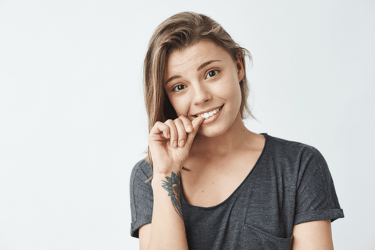 A nervous young girl biting her nails