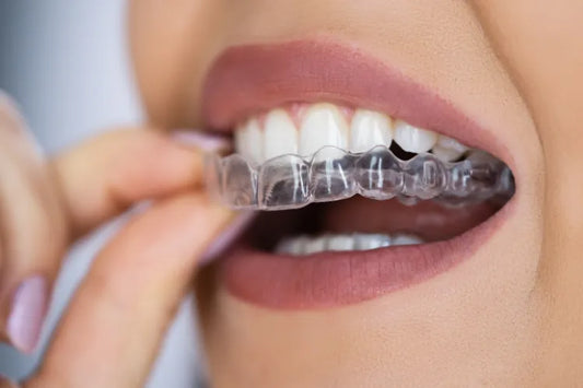 A woman applying a dental night guard.