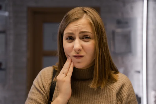 Woman with hand on her cheek.