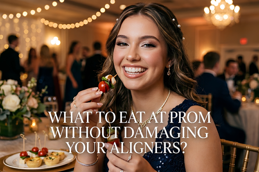 Young woman smiling at prom while holding appetizers and wearing a navy blue dress.