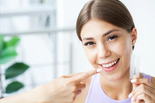 a girl holding whitening strips